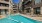 a pool in a courtyard between buildings
