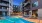a swimming pool in a courtyard between buildings