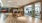 a large room with a wood floor and a large glass wall
