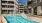 a swimming pool in a courtyard between buildings